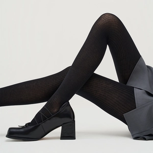 Detailed texture of black vertical striped tights paired with chic Mary Jane shoes