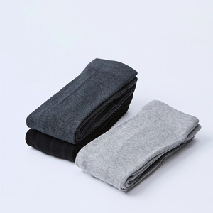 Detail view of elastic knitted tights showing vertical texture in grey and black colors