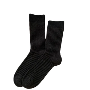 Solid black wool knit crew socks with classic vertical ribbed texture and elastic cuffs