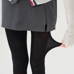 Close-up of black vertical ribbed tights showing high elasticity and knit texture