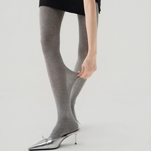 Detail showing the high elasticity and soft knit texture of gray slimming tights
