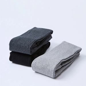 Detail view of vertical ribbed texture on gray and black slim-fit cotton stockings