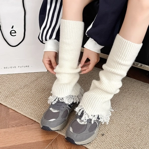 Knitted flared leg warmers with grey fringe detail for a stylish winter layered look