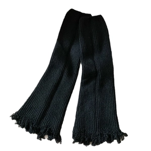 Black ribbed knit leg warmers with flared fringe hem and Y2K aesthetic style