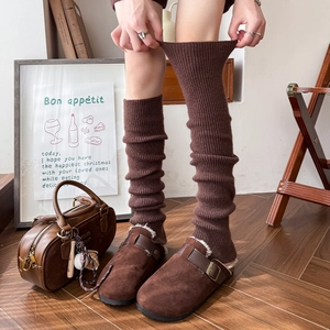 Thick warm dark brown ribbed knit leg warmers for women in cozy home setting