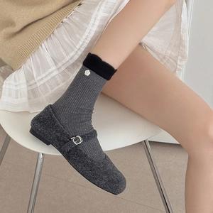 Grey Mary Jane shoes with floral knit crew socks and contrast lace-up details