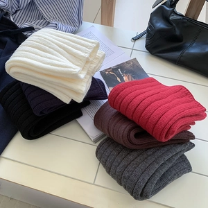 Detailed view of thick ribbed knit leg warmers in various solid fashion colors