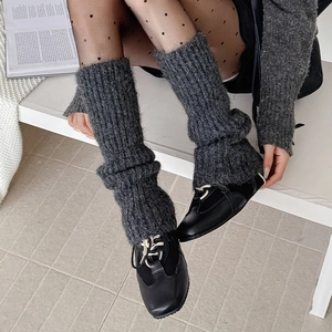 Thick grey knit leg warmers with vertical ribs paired with black shoes for winter