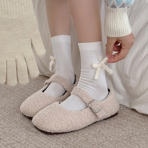 White ribbed mid-calf socks with bow and flower detail paired with plush Mary Jane shoes