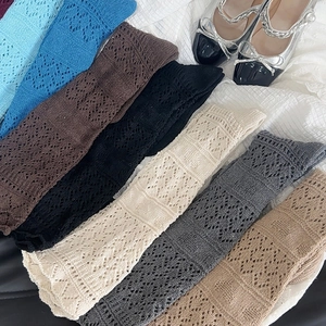 Detailed knit texture of vintage hollow-out socks in various colors with lace accents