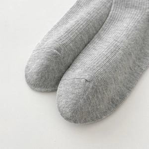 Gros plan sur les chaussettes en coton gris clair montrant les détails des orteils