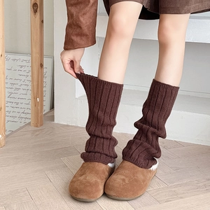 Deep brown ribbed knit leg warmers in a slouchy style for cozy winter warmth