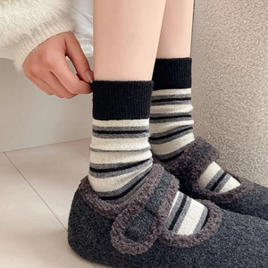Close-up of striped wool mid-calf socks with soft texture and classic grey stripes