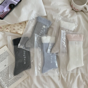 Detail of five-pair ribbed mid-calf socks set in premium branded zip-lock packaging