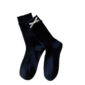 Sweet black mid-calf socks featuring white silk bows and ruffled edges in ribbed knit style