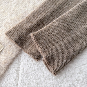 Close-up of ribbed knit texture in coffee brown with soft wool blend details