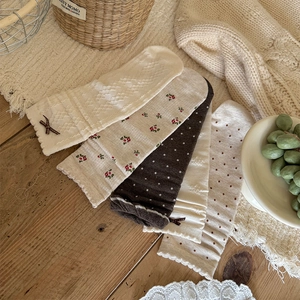 Detailed close-up of 5-pair sweet vintage knit socks with lace bows and floral patterns