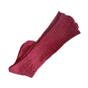 Deep red knit leg warmers featuring intricate hollow crochet diamond patterns and wavy edges