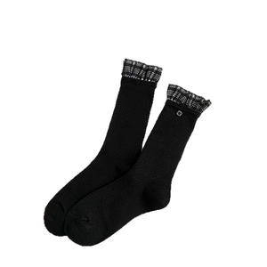 Chic black crew socks with plaid ruffle trim and silver button accent for a sweet style
