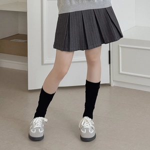 Japanese style gray vertical stripe knee high socks paired with a minimalist pleated skirt