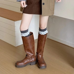 Brown leather boots with grey lace trim socks and metallic buckle accents