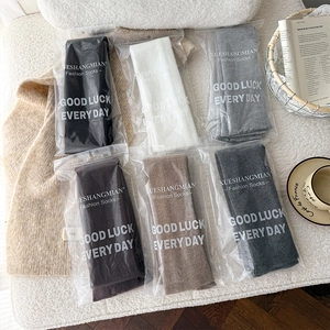 Detail view of 6-pack warm knitted over-knee socks in assorted colors with premium zip bags