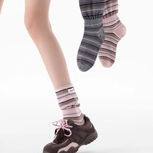 Texture de maille détaillée des chaussettes rayées gris et rose avec étiquettes blanches