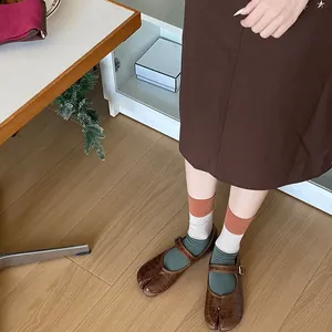 Retro tabi shoes and patchwork socks styling with textured brown split-toe loafers