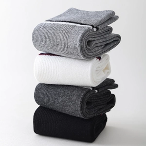 Detailed knit texture of 4-pack striped knee-high school socks in gray, white, and black