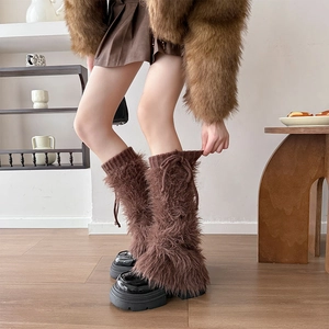 Detail of dark brown faux fur leg warmer with knitted ribbed cuff and adjustable tie string