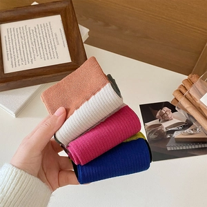 Close-up of color-block split-toe crew socks with vertical rib knit texture details
