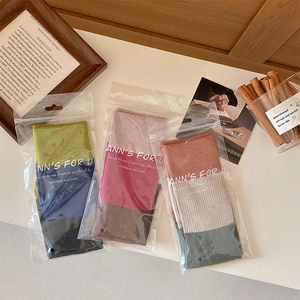 Three pairs of vintage patchwork two-toe socks packaged in transparent zipper bags