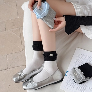 Detail of Korean style two-tone socks with ruffled edges and metal button accents