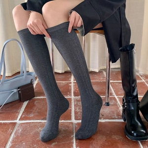 Dark grey knee-high rib-knit socks in a stylish minimalist design for a cozy look