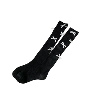 Ballet style black ribbed knee-high socks with white silk bow accents and slimming knit texture