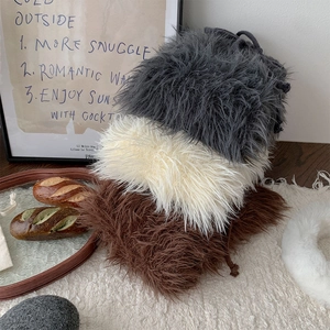Detailed view of plush faux fur leg warmers in grey, white, and brown fluffy textures