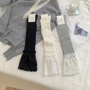 Detailed knit texture and floral lace trim on socks in black, cream, and grey colors