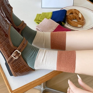 Retro color-block ribbed crew socks for women featuring a stylish tri-color patchwork design