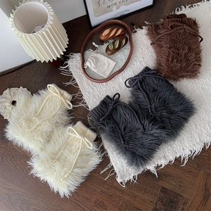 Furry leg warmers detail featuring plush faux fur texture and knit drawstring with bow