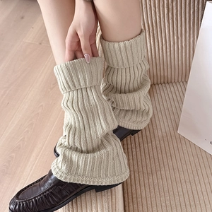 Oatmeal knit leg warmers in thick ribbed style paired with stylish black leather loafers