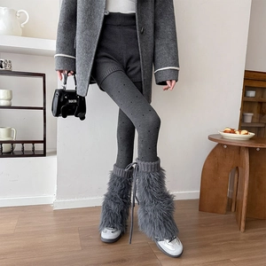 Detail of grey faux fur leg warmers with drawstring ties and polka dot tights