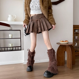 Detailed view of a brown pleated A-line mini skirt with a thin knotted waist belt