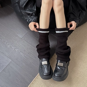Japanese style black ribbed knit leg warmers with white stripes and casual loafers