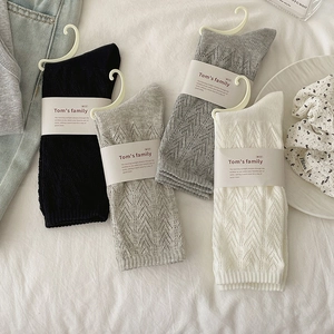 Detailed hollow diamond knit pattern on mid-calf socks in white, black and grey tones