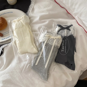 Detailed set of lace trim mid-tube socks with bows in cream, grey, and black colors