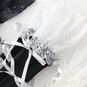 Detail of Lolita leg warmers with delicate lace trim and white silk ribbon bows