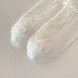 Detailed close-up of white ribbed knit ballet socks toe with smooth stitching finish