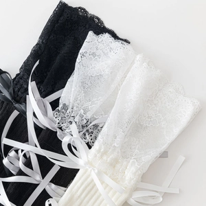 Detail of Lolita leg warmers with floral lace trim and ribbon bow accents