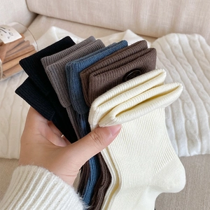 Close-up of assorted ribbed knit mid-calf socks in coffee, grey, and blue tones
