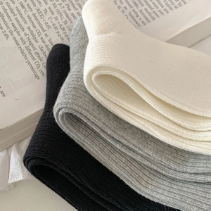 Close-up of ribbed knit cotton calf socks in black, grey and white colors